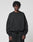 A man wearing the LIVE FAST DIE YOUNG Basic Evidence Sweater, an oversized black cotton-polyester sweatshirt with stylish front and back prints.