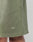 Close-up of the hem of green Basic Sweat Shorts by LIVE FAST DIE YOUNG, featuring small white LFDY text near the bottom edge. Part of a persons leg is visible below the hem.