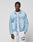A man wears a LIGHT FAST DIE YOUNG LFDY Trucker Jacket in light blue denim over a white t-shirt and light gray Regular Fit Baumwolle sweatpants with text on the left leg, standing against a plain light gray background.