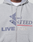A close-up of a person wearing the LIVE FAST DIE YOUNG Flannel Lined Hooded Jacket in light gray, featuring a flannel lining, drawstrings, embroidered "LIVE" and "Fast," and a bold blue geometric front design.