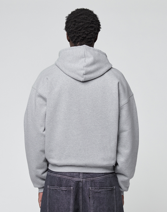 A person with short, curly hair is shown from behind, wearing a light gray LIVE FAST DIE YOUNG Flannel Lined Hooded Jacket and dark jeans against a plain light background.