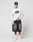 A man in an oversized gray LFDY Emblem Sweater by LIVE FAST DIE YOUNG, featuring a subtle logo embroidery, black cap, black denim shorts, white socks, and white sneakers stands against a plain white background.