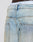 Close-up of the back of a person wearing LIVE FAST DIE YOUNG’s LFDY Baggy Denim in light blue, faded wash, with two back pockets and a white waistband marked LJST.