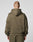 A person with a shaved head is shown from behind in a LIVE FAST DIE YOUNG Live Fast Sweatsuit Jacket, oversize fit olive green, hood up, against a plain light gray background.