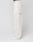 A person stands sideways in off-white LIVE FAST DIE YOUNG Worker Pants, 100% cotton, loose fit with a visible branded waistband and carpenter pocket, paired with white sneakers against a plain background.