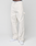 A person wearing LIVE FAST DIE YOUNG Worker Pants with a baggy fit and carpenter pocket, featuring a white waistband with "LIVE FAST" text, paired with white sneakers against a plain light background.