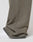 A close-up shows the lower leg in LIVE FAST DIE YOUNG’s LFDY Ripped Sweatpants—loose, olive-green with frayed hems and a Wide Fit, made from 100% Baumwolle with an Elastikbund, partially covering a white sneaker against a plain background.