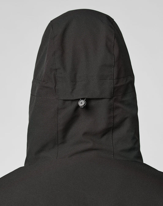 A close-up of the back of the LIVE FAST DIE YOUNG Basic Shell Jacket in black Oversize Fit, highlighting the hood with a small adjustable drawstring toggle and a reflektierender Druck for added style.