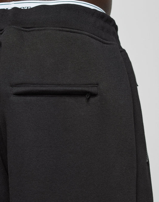Close-up of the LFDY Active Fleece Jogger by LIVE FAST DIE YOUNG, featuring a black back pocket with pull tab, subtle logo print detail, and waistband with a glimpse of striped elastic band.