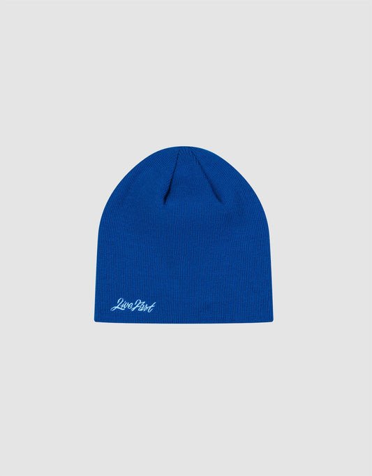 The LIVE FAST DIE YOUNG Script Beanie is a plain blue polyacryl knit hat in One Size, featuring a small white “Logo-Stick” script near the bottom edge, shown on a light gray background.| plain 