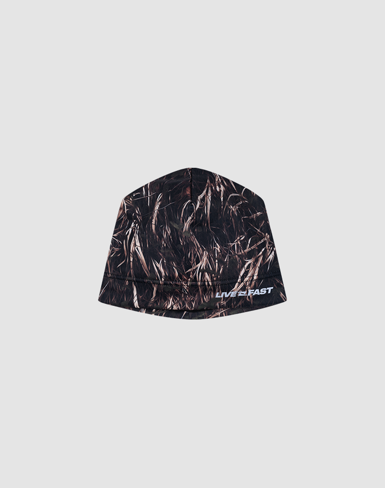 The Live Fast Performance Beanie by LIVE FAST DIE YOUNG features a brown and black grass camo pattern, a reflective logo print, and "LIVE FAST" in white on the front. Made from polyester with a warm fleece lining for comfort.
