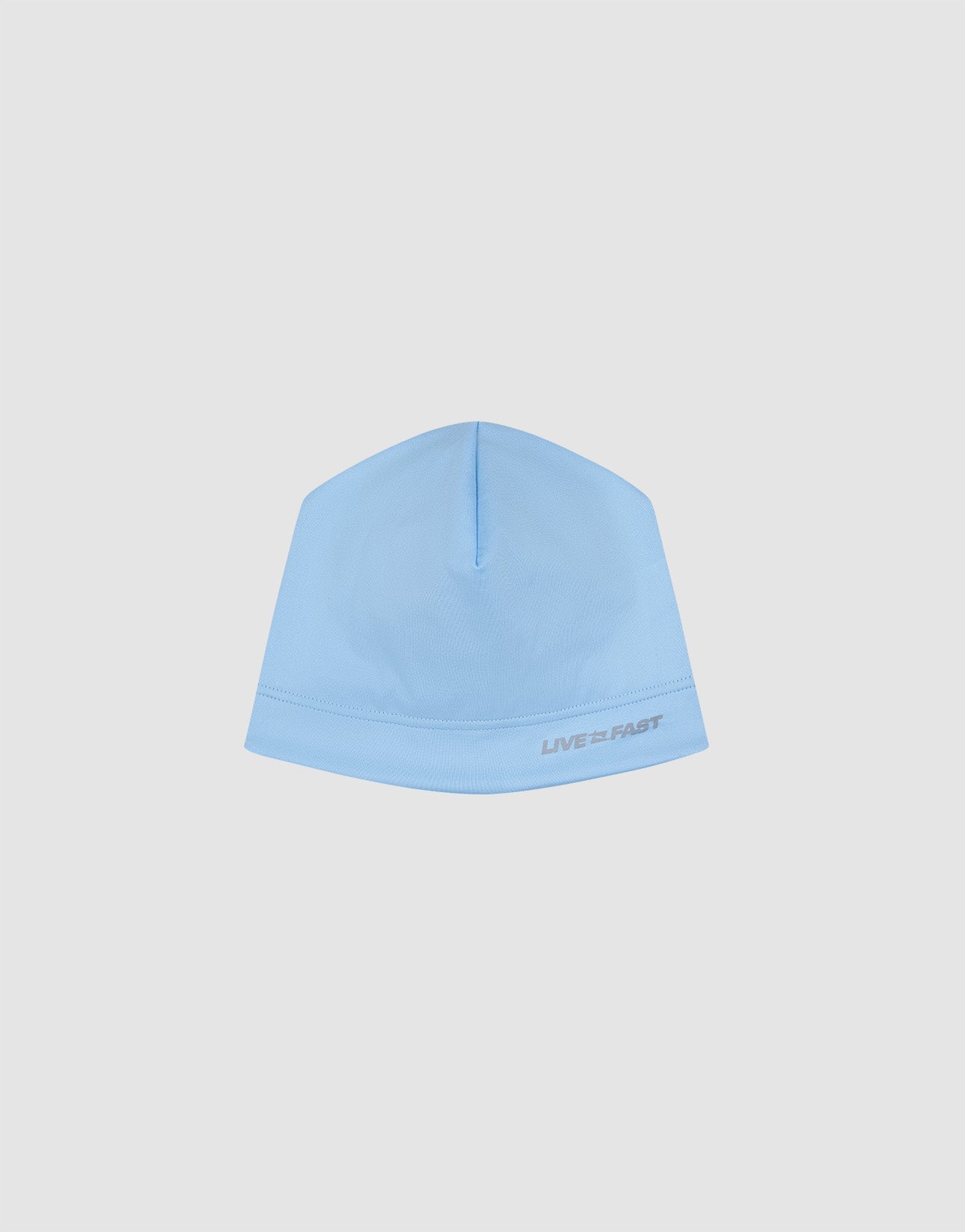 The Live Fast Performance Beanie by LIVE FAST DIE YOUNG features a light blue fitted design with "LIVE FAST" in small gray text near the edge, shown against a plain white background.| plain