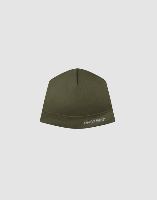 The Live Fast Performance Beanie by LIVE FAST DIE YOUNG is an olive green fitted hat with a white and grey "LIVE FAST" reflective logo on the front, thin fleece lining, shown on a plain light grey background. 