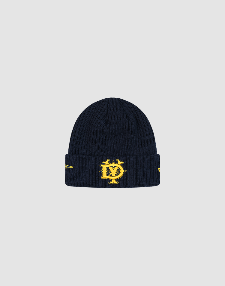 The LFDY x New Era Beanie by LIVE FAST DIE YOUNG features navy blue ribbed knit, a folded brim, yellow embroidered DY Logo with yellow designs, and stands out sharply against a light gray background. 