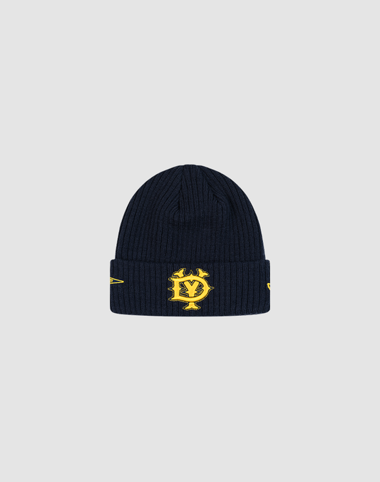The LFDY x New Era Beanie by LIVE FAST DIE YOUNG features navy blue ribbed knit, a folded brim, yellow embroidered DY Logo with yellow designs, and stands out sharply against a light gray background. 