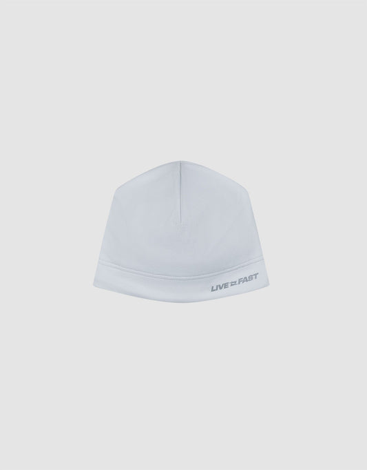 The Live Fast Performance Beanie by LIVE FAST DIE YOUNG is a plain white fitted beanie with "LIVE FAST" in gray on the lower right, featuring a dünne Fleece Innenseite, displayed on a light gray background.