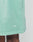 Close-up of a person wearing mint green Basic Sweat Shorts from LIVE FAST DIE YOUNG with white LFDY™ embroidery near the hem; their hand appears at the top left.