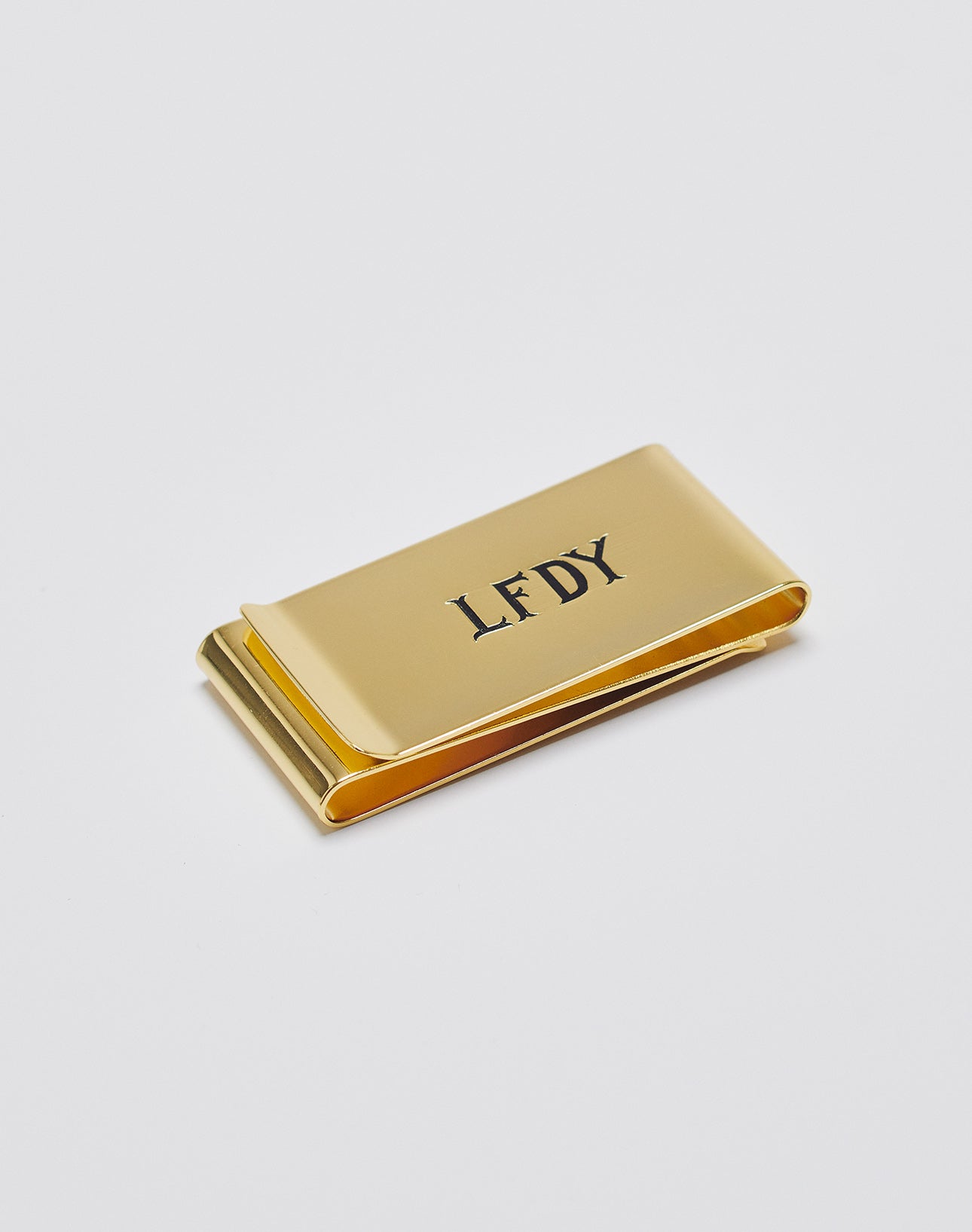 The Basic Money Clip by LIVE FAST DIE YOUNG, made from stainless steel and featuring the engraved LFDY logo on top, is shown on a plain white background.| plain