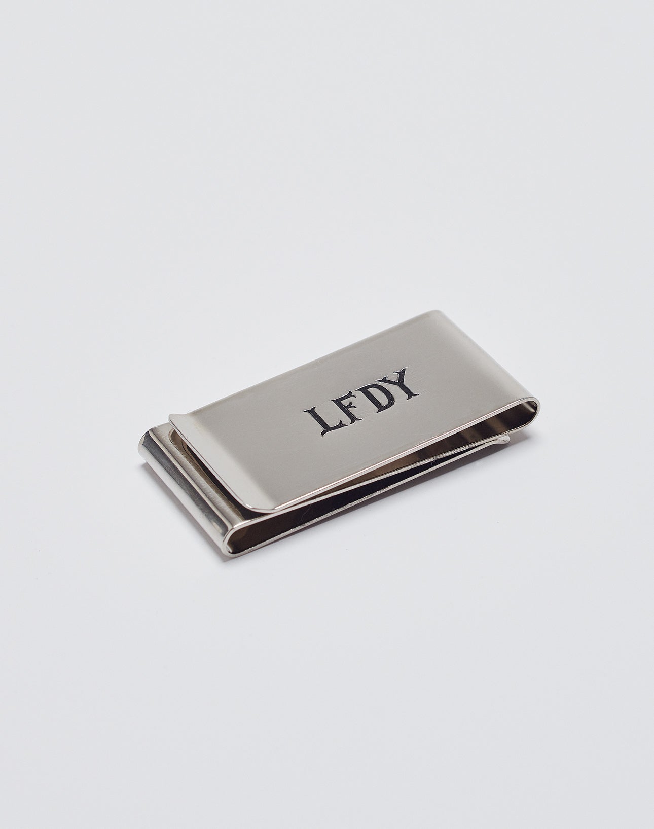 The Basic Money Clip by LIVE FAST DIE YOUNG, made of stainless steel (Edelstahl) with a LFDY engraved logo, Modellnummer LF2305-13597, is displayed on a plain white background.| plain