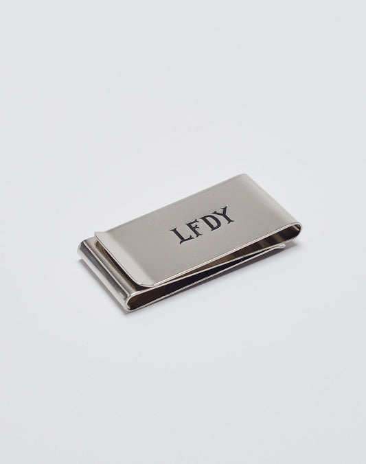 The Basic Money Clip by LIVE FAST DIE YOUNG, made of stainless steel (Edelstahl) with a LFDY engraved logo, Modellnummer LF2305-13597, is displayed on a plain white background. 
