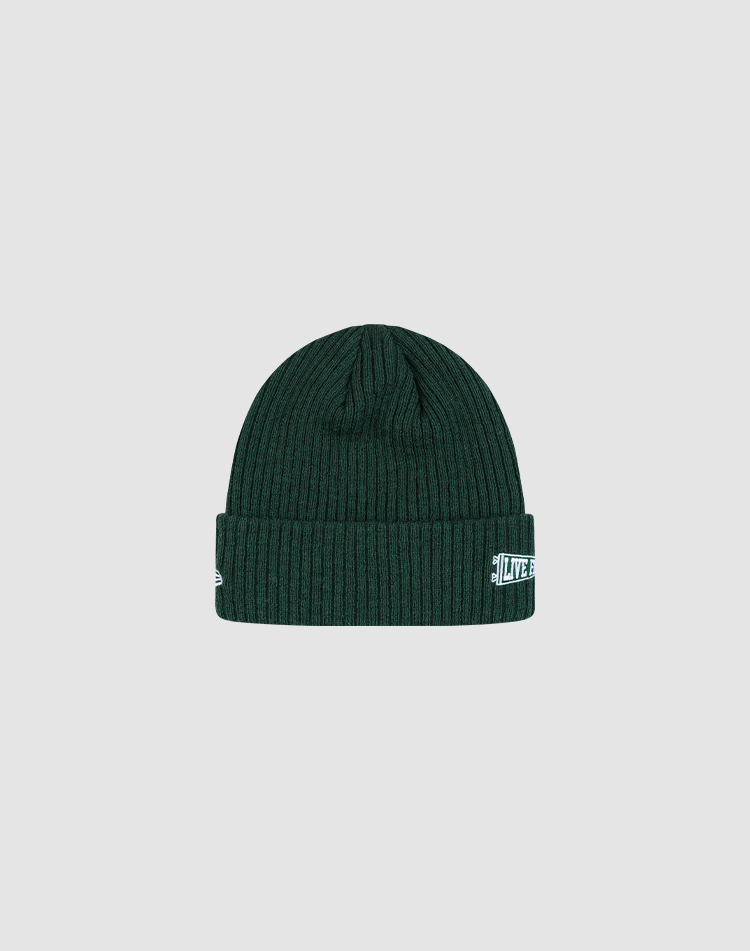 The LFDY x New Era Beanie by LIVE FAST DIE YOUNG is a dark green ribbed knit beanie with a folded brim and small white DY Logo patch on the front, shown against a plain light gray background.
