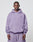 A man faces forward in an oversize, light purple Basic 360 Hooded and matching sweatpants by LIVE FAST DIE YOUNG, both featuring LiveFast text, made from Baumwolle Polyester, against a plain white background.