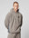 Someone with short hair wears the LIVE FAST DIE YOUNG Live Fast Fleece Halfzip, a loose, light gray, oversized fleece pullover with a half-zip and small black chest logo, standing against a plain light background.