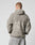 Seen from behind, a person with short hair wears the Live Fast Teddy Jacket by LIVE FAST DIE YOUNG, featuring an oversize fit, hood, and large embossed LIVE FAST branding on the back. They style it casually with light-wash jeans.