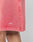 A close-up of a person wearing LIVE FAST DIE YOUNG Basic Sweat Shorts in pink, featuring an elastic waistband and a white LFDY™ logo near the hem. Only part of the leg and the subtly faded lower shorts are visible.