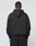 A person, back to camera, wears the LIVE FAST DIE YOUNG Basic Blank Hooded in an Oversize Fit with matching black pants made from a soft Baumwolle-Polyester blend, standing against a plain light gray background.