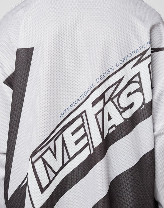A close-up of the LFDY Racetrack Jersey by LIVE FAST DIE YOUNG shows its white polyester mesh with bold black “LIVE FAST” text and smaller blue “INTERNATIONAL DESIGN CORPORATION” above, designed in an oversized fit.