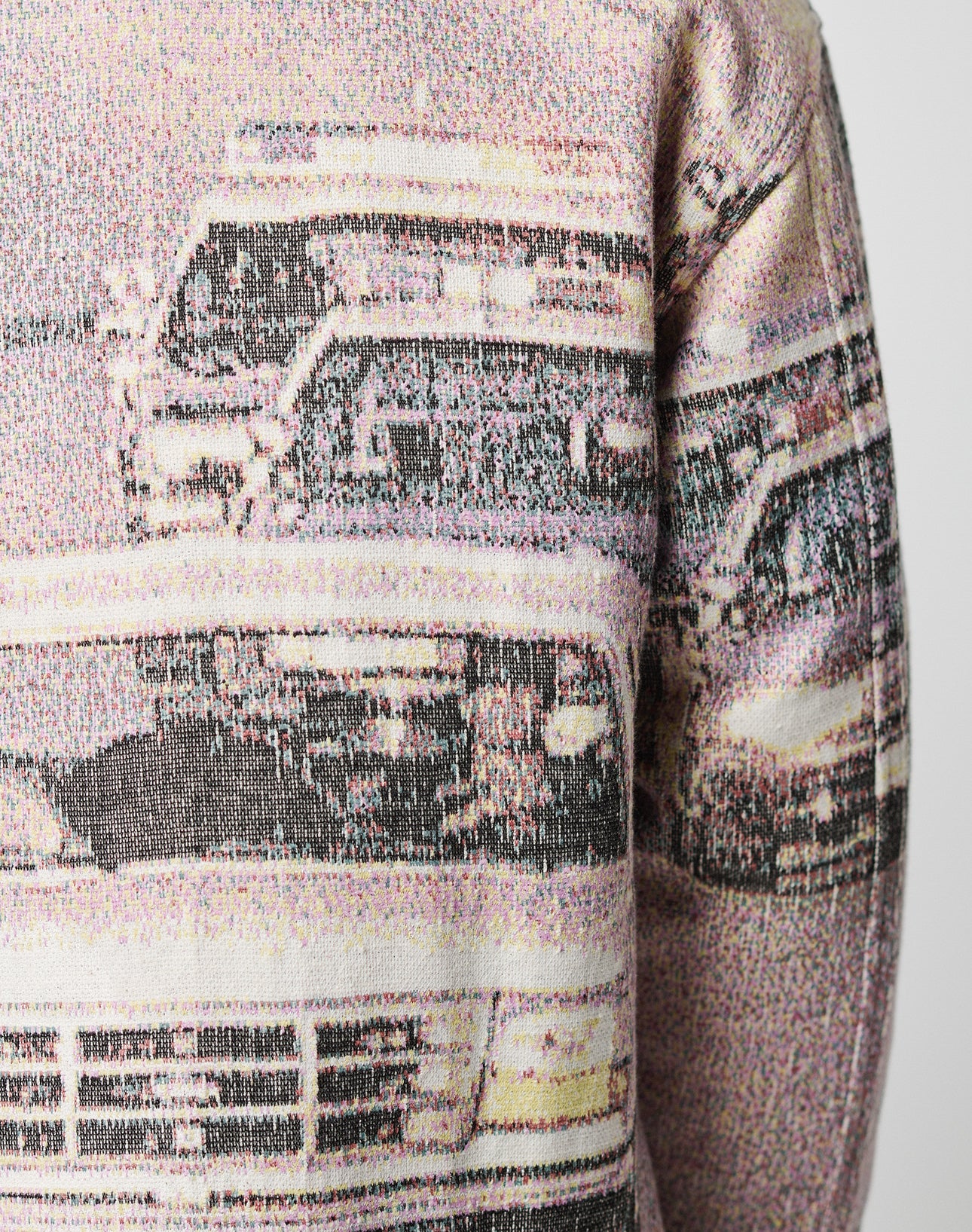 A close-up of the LIVE FAST DIE YOUNG LFDY Chase Jacket, featuring an oversize fit and pixelated vintage car print, shown from the front with focus on the upper torso and sleeve against a plain background.