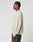 A person stands in profile against a plain background, wearing the off-white LIVE FAST DIE YOUNG LFDY Praying Fuzzy Sweater with Rundhals neckline and Oversize Fit, paired with dark pants.