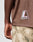 A person is seen from the back wearing the LIVE FAST DIE YOUNG LFDY Mesh Jersey—a brown, oversized mesh shirt with a LIVEFAST logo patch—paired with camouflage pants and one arm visible.