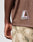 A person is seen from the back wearing the LIVE FAST DIE YOUNG LFDY Mesh Jersey—a brown, oversized mesh shirt with a LIVEFAST logo patch—paired with camouflage pants and one arm visible.