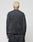 A person with short, bleached blonde hair is seen from behind wearing the LIVE FAST DIE YOUNG LFDY Emblem Ghost Waffle Longsleeve and matching dark gray pants against a plain light gray background.