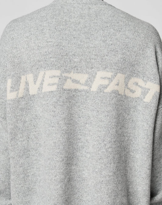 The Live Fast Boucle Sweater by LIVE FAST DIE YOUNG is a gray, 100% polyester piece with an oversize fit and bold white LIVE FAST lettering across the upper back.