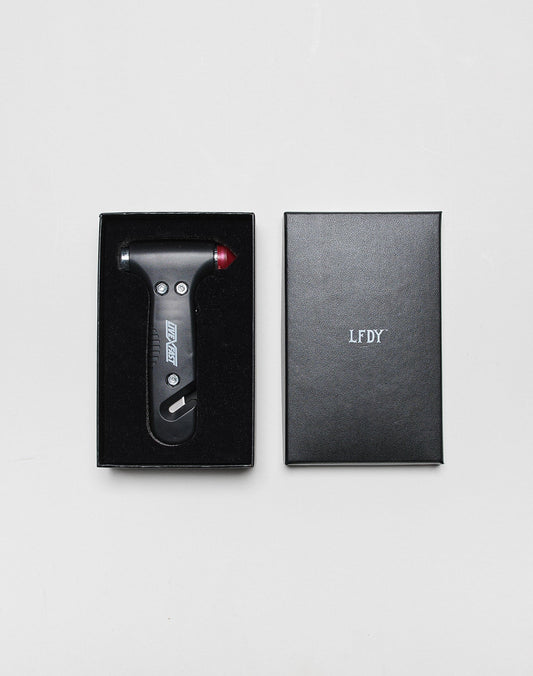 The LFDY Emergency Hammer by LIVE FAST DIE YOUNG, model LF2503-16986, is a black tool with a red tip. Shown in an open and closed branded box with a subtle logo print, all displayed on a plain white background. One size.