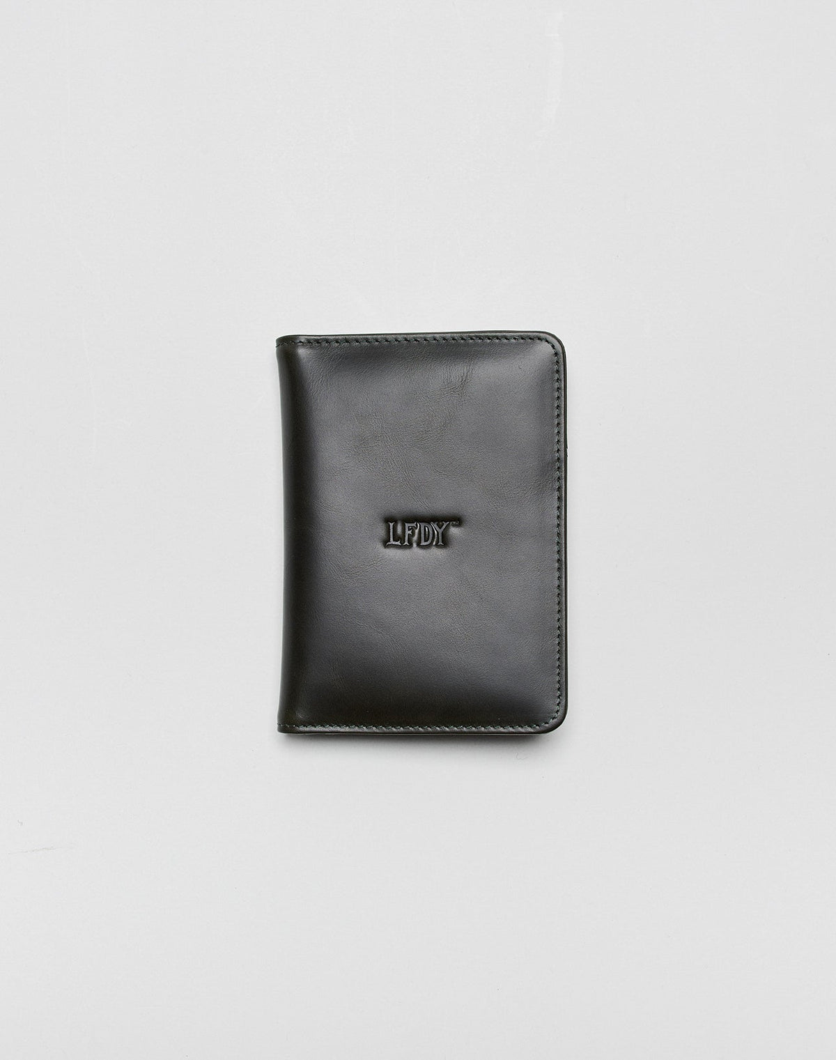 A closed black LFDY Passport Case by LIVE FAST DIE YOUNG with rounded corners, center LFDY embossing, and multiple card slots, shown on a plain light gray background. 