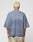 A person with short, bleached blonde hair is shown from the back wearing the LIVE FAST DIE YOUNG Faded Waffle Jersey, an oversize fit faded blue shirt made of 100% Baumwolle, paired with light patterned pants against a plain background.