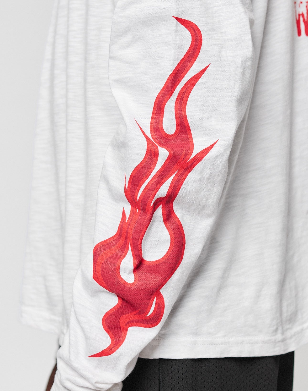 The LFDY We Walked Longsleeve by LIVE FAST DIE YOUNG is an oversized white 100% cotton shirt featuring a striking red flame graphic down the sleeve.