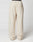 The LFDY Pleated Jogger by LIVE FAST DIE YOUNG is a wide-fit, cream sweatpant made of soft cotton with an elastic waistband and a patch pocket on the left thigh, modeled against a plain white background.