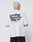 A person with short blond hair wears a white oversize Basic 280 Tee by LIVE FAST DIE YOUNG, featuring bold black backprint text and smaller text below, made from 100% cotton, standing against a plain white background.
