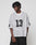 A person with short, textured hair models the oversized LFDY Mesh Jersey by LIVE FAST DIE YOUNG in gray polyester mesh with black number 13 on the front and sleeve, paired with black pants against a plain background.