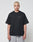 A person with short bleached blond hair wears a loose black LIVE FAST DIE YOUNG Basic 280 Tee with backprint and gray mesh shorts in an oversize fit, standing against a plain white background.