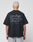 A person with short, bleached blonde hair is shown from behind, wearing a black LIVE FAST DIE YOUNG Basic 280 Tee with a bold backprint. The background is plain white.