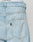 Close-up of the back pocket on LFDY Distressed Baggy Denim in a baggy fit, showing a small black LIVE FAST DIE YOUNG tag. The waistband of white underwear with partial LIVIAST text is visible above the jeans.