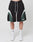 Someone wearing LIVE FAST DIE YOUNGs Basic Trackshorts with a logo print, elastic waist, and white/dark green curved stripes, paired with LFDY logo socks and white sneakers, stands against a plain white background.