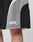 Close-up of a person wearing Basic Trackshorts by LIVE FAST DIE YOUNG in black and gray with elastic waistband and logo print. Live Fast Die Young is written in white on the lower left leg. Part of the thigh is visible.