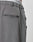 Close-up of the back of gray Wide Casual Pants by LIVE FAST DIE YOUNG with a straight leg and welt pocket. The white underwear’s elastic waistband, featuring LIVE FAST, is visible above the pants.